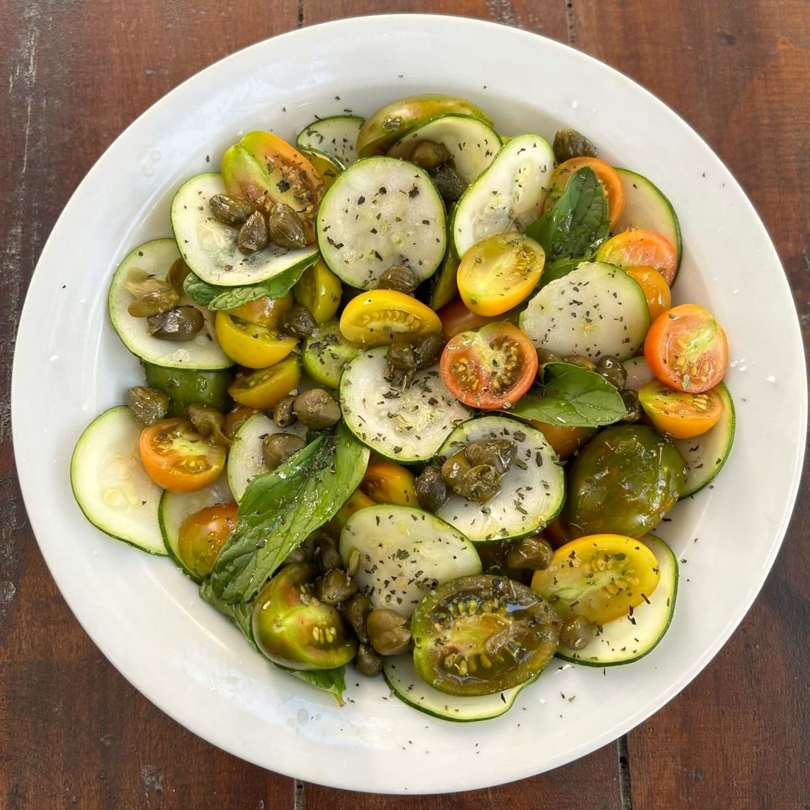 Organic seasonal salad — zucchini, tomatoes, capers, mountain mint.