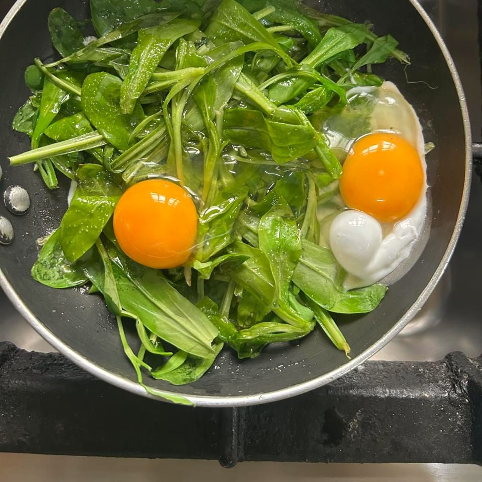 Strouthkia me ta afka — wild greens and eggs, the old way.